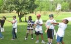 Children from the day camp learn the musket drill with dummy guns.