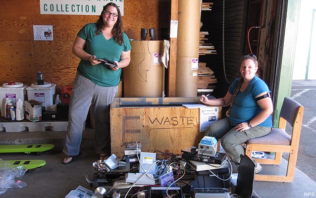Facility Management Specialist Sara Hammond and IT Specialist Aimee Davis sort E-waste for recycling