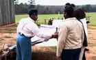 Young man portraying a Union prisoner of war interacts with students