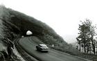 Historic photo from the mid 20th century of cars driving along the Blue Ridge Parkway.