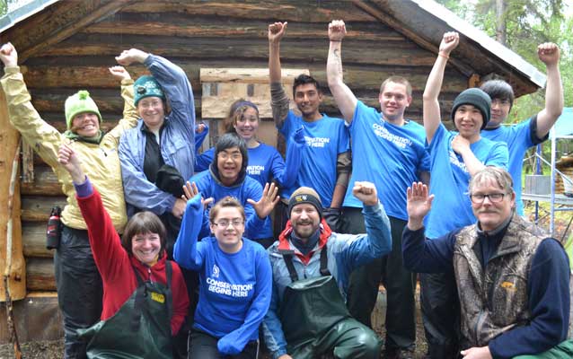 SCA Trail Crew celebrates their work on the trail from the historic cabin.
