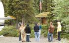 K. Schubeck, a volunteer at the remote Proenneke Historic Site for 13 years, gives a tour for wounded veterans and their spouses.