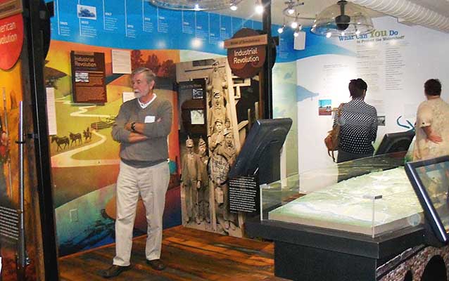 Visitors enjoy colorful displays on the Industrial Revolution at the center's grand opening.