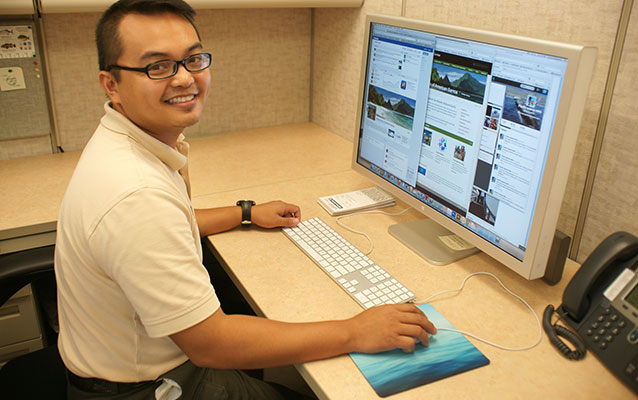 Photo of Park Ranger Eymard Bangcoro posting to the National Park of American Samoa's Facebook, Twitter, and blog pages.