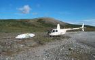 helicopter sits next to discarded, 1970s-era fuel pod