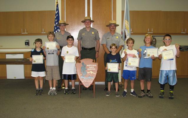 Campers receive their Junior Ranger Badge and Certificate from Park Rangers