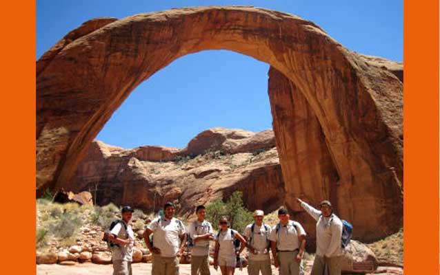 Native Conservation Corps participants in front of Rainbow Bridge natural arch