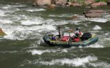 Park Rangers guide a raft through rapids on the Green River