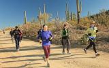BEYOND participants running on a dirt road among the saguaro cactus in Saguaro National Park 