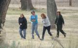 Three students and a ranger after playing the shinny stick game.