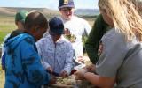 Kids preparing food for campfire cooking program.