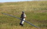 YCC employee moving irrigation pipe.