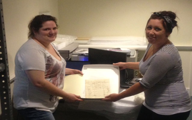 Park Interns Caroline Davis and Kaylah Rodriguez with the 1860 Stone Family Census Record
