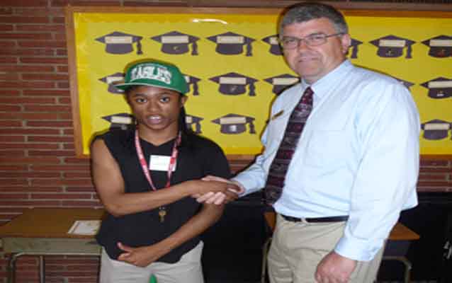 Park employee shaking hands with student who is giving thumbs up sign