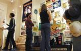 Three visitors enjoy displays at the Rivers of Steel Visitor Center, including a number of metal signs from earlier steel industry days.