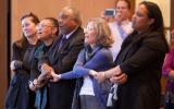 Conference attendees join hands during a performance of Civil Rights songs