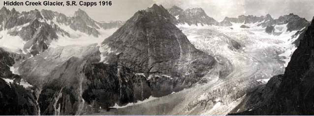 black and white image of a large glacier curling around a spire of mountain