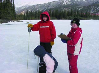 three kids standing on a frozen lake