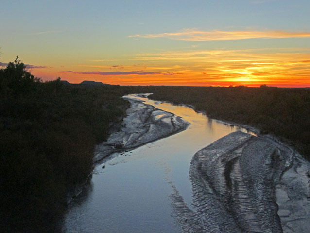 A calm, winding river at sunset