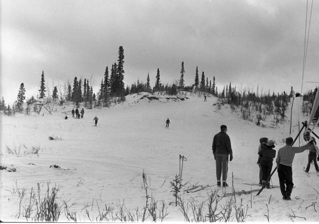 historic image of people skiing on a hill