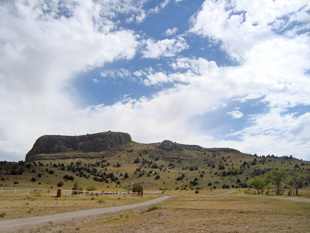 View of the distinctly-shaped rock formation known as "Wagon Mound" in an otherwise flat landscape