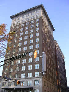 Outside the Ellis Hotel, a tall brick building