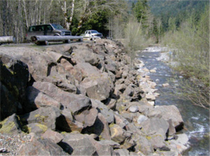 Large boulders make up riprap along the river