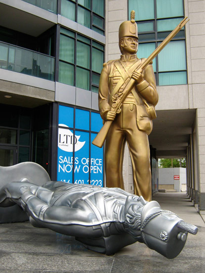 Statue of gold and fallen silver toy soldiers