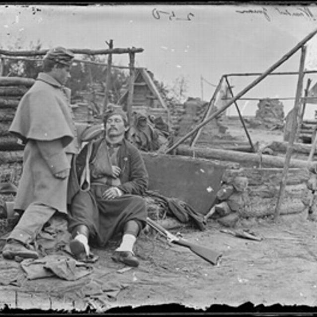 Photograph of two soldiers, one wounded
