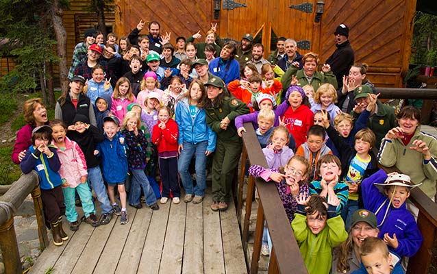 children, rangers and education center instructors strike goofy poses