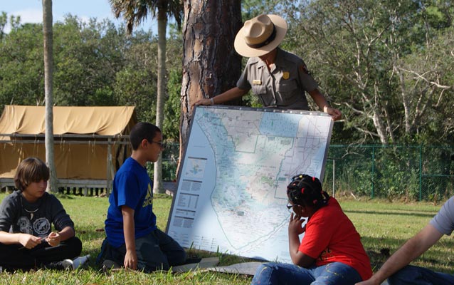 Students study a map of South Florida