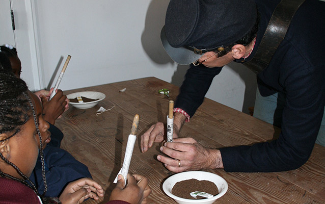 Students rolling mock rifle cartridges.
