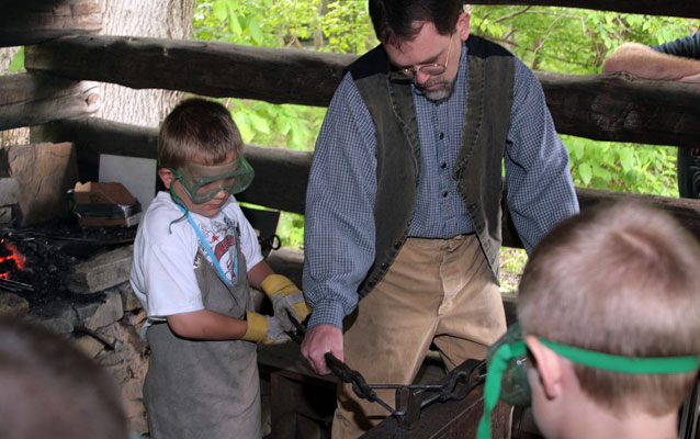 student works in a blacksmith shop