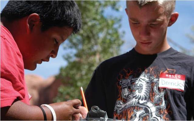 Students record the temperature of different surfaces.