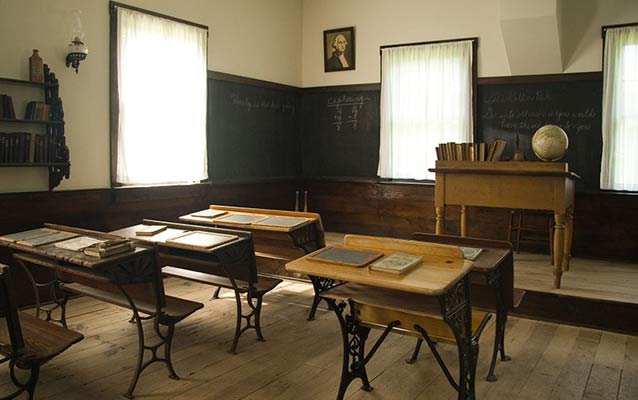 Wooden desks furnish a historic one-room schoolhouse.