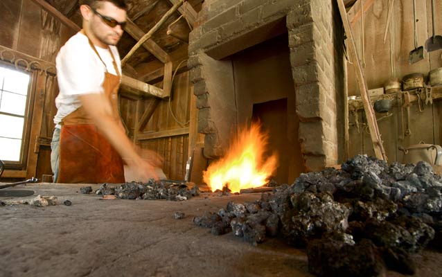 A blacksmith working at a traditional forge.