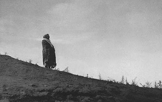 Image of Hidatsa woman on a hilltop.