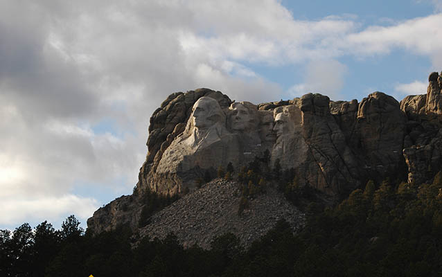 Mount Rushmore under late afternoon sun.