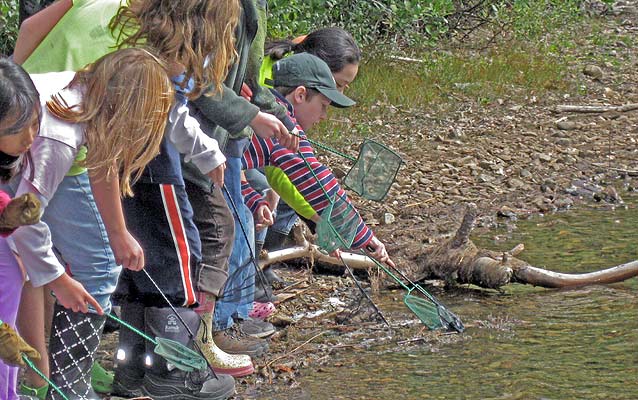 Two students explore wildlife biology with a ranger.