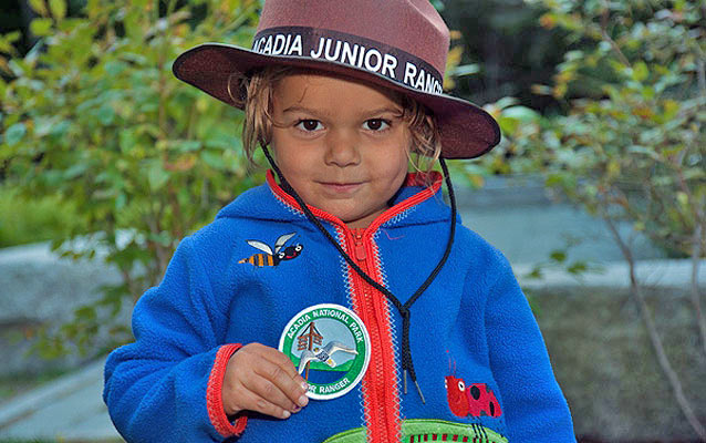 A proud new Junior Ranger shows off her official patch.