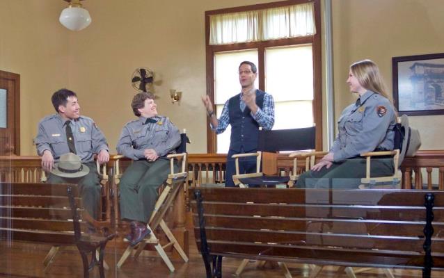 Park rangers with host in the historic Hearing Room during the live Webcast