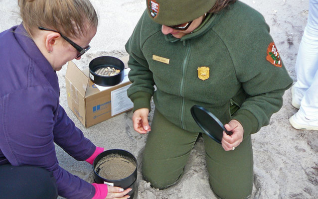 A park ranger and educator conduct the Sorting Sand activity during a recent Teachers Workshop.