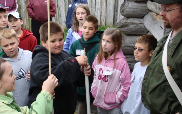 Students loading pretend muskets inside Fort Necessity
