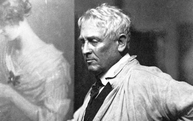 A mature Julian Alden Weir stands in his studio.