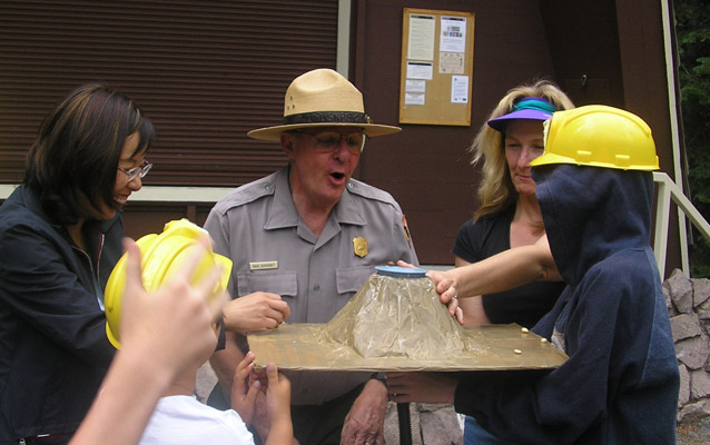 Teachers and students use a volcano model with a park ranger