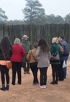 Park ranger talks with visitors at the prison site Park ranger talks with visitors at the prison site