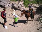 Ranger on horse patrol interacts with family