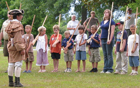 reenactor teaching musket drill to visitors