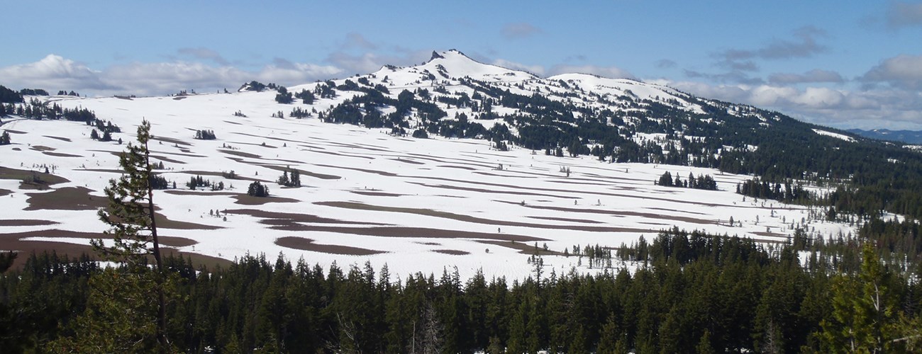 Pumice meadow partially covered in melting snow