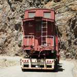 Caboose being hauled to maintenance yard after being removed from trestle.